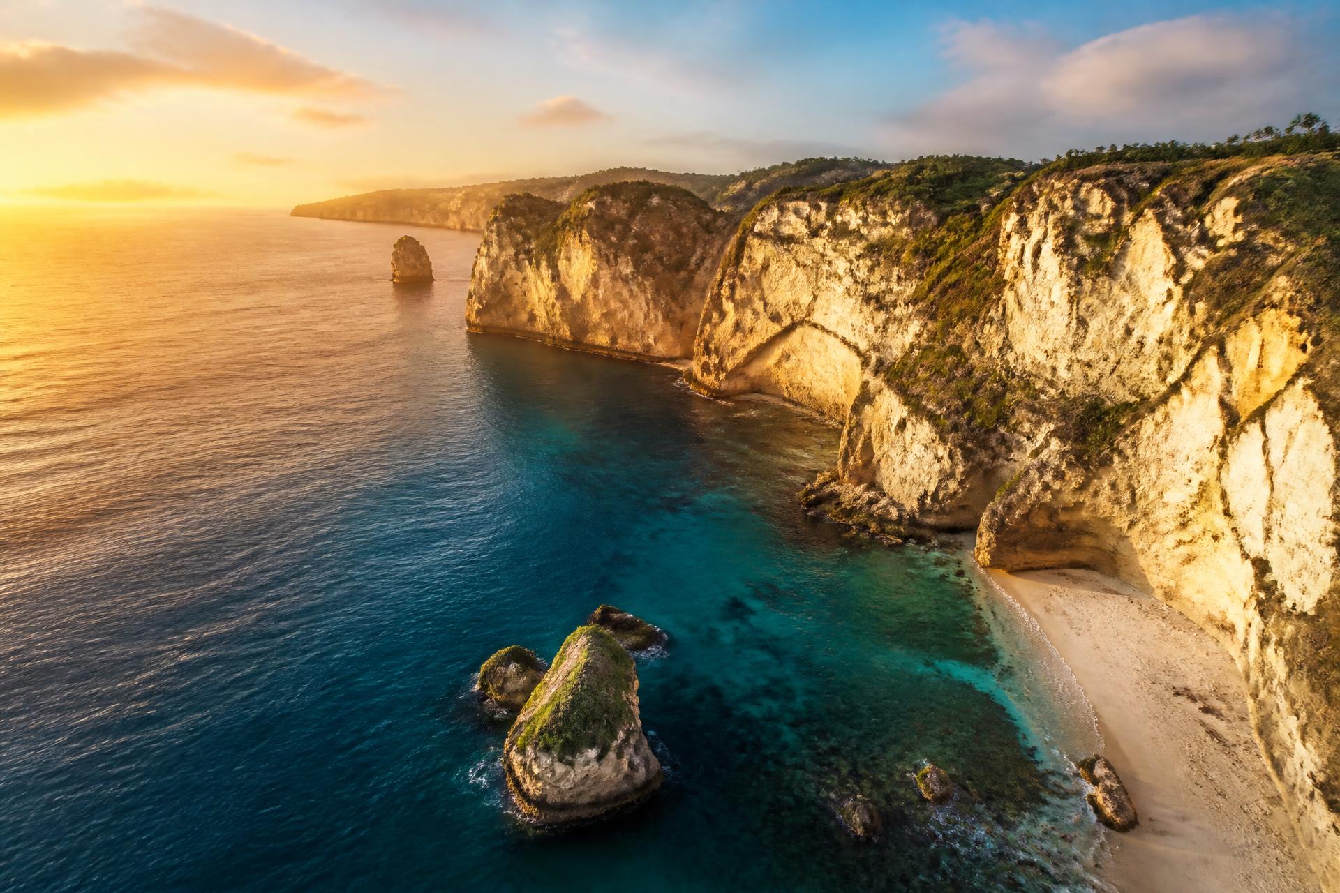 Aerial view of a turquoise coastline at golden hour